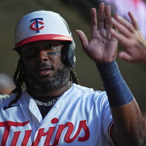 Minnesota Twins designated hitter Josh Bell celebrates in the dugout after scoring off a RBI single hit by Kody Clemens during the first inning of a baseball game against the Atlanta Braves, Monday, Aug. 17, 2026, in Minneapolis. (AP Photo/Abbie Parr)