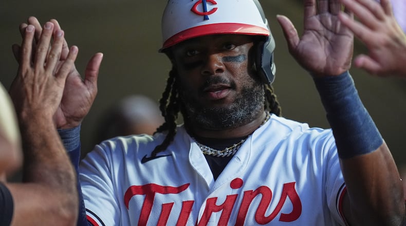 Minnesota Twins designated hitter Josh Bell celebrates in the dugout after scoring off a RBI single hit by Kody Clemens during the first inning of a baseball game against the Atlanta Braves, Monday, Aug. 17, 2026, in Minneapolis. (AP Photo/Abbie Parr)