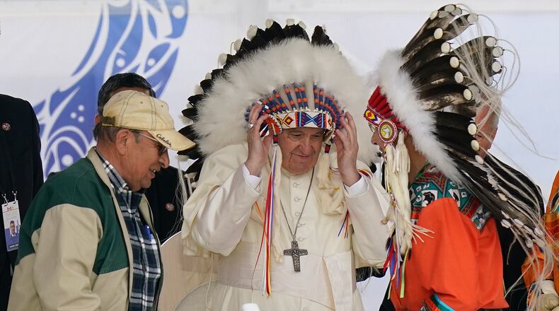 FILE - Pope Francis dons a headdress during a visit with Indigenous peoples at Maskwaci, the former Ermineskin Residential School, Monday, July 25, 2022, in Maskwacis, Alberta. (AP Photo/Eric Gay, File)