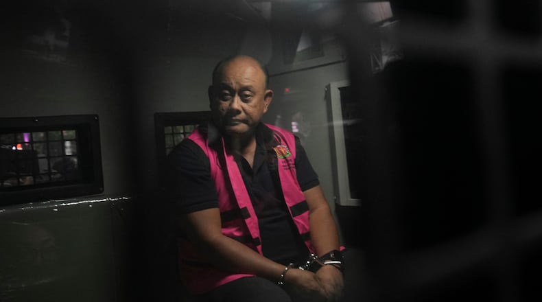 Former head of Indonesia's National Nutrition Agency Dadan Hindayana sits inside a detention car after being named as a corruption suspect, at the Attorney Genera's Office in Jakarta, Indonesia, Wednesday, June 3, 2026. (AP Photo/Achmad Ibrahim)