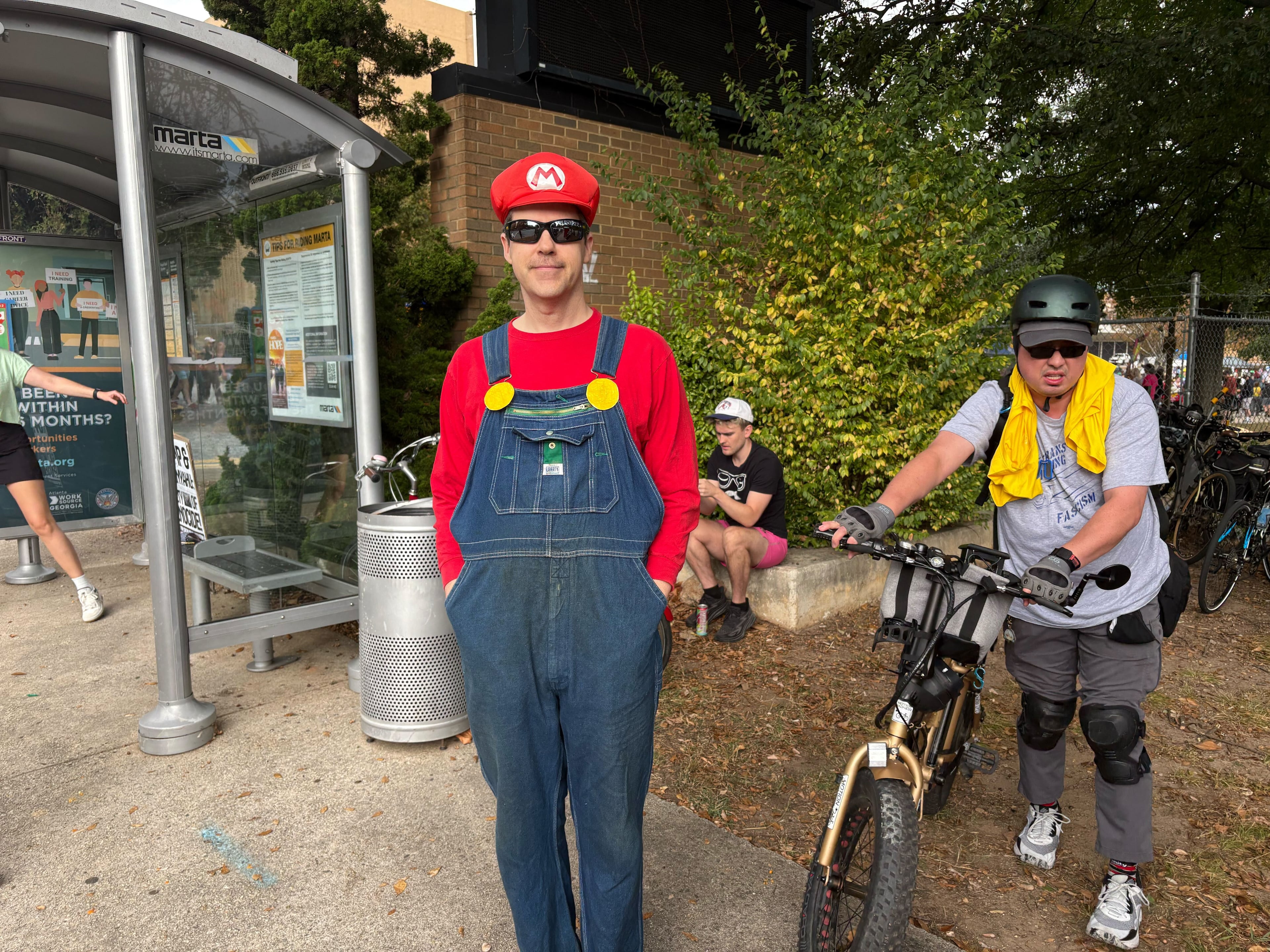 Sandy Springs resident Grant Flowers opted dressed up as “Mario” to a "No Kings" protest in Atlanta. (Shaddi Abusaid / AJC)