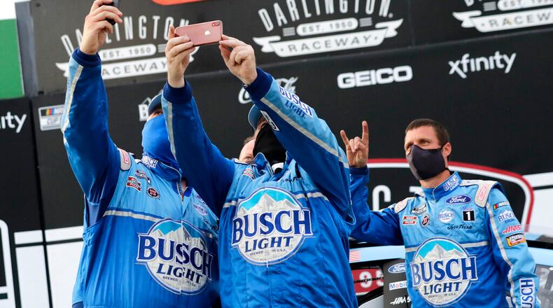 Members of Kevin Harvick's team celebrate after winning the NASCAR Cup Series auto race Sunday in Darlington, S.C.