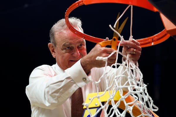 Texas head coach Vic Schaefer cuts down the net to celebrate a win over TCU in the Elite Eight of the NCAA college basketball tournament, Monday, March 31, 2025, in Birmingham, Ala. (AP Photo/Butch Dill)