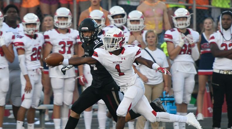 Milton CB Tyreek Rock (1) tries to get his hand on the ball before Alpharetta's Austin Frazier (24).