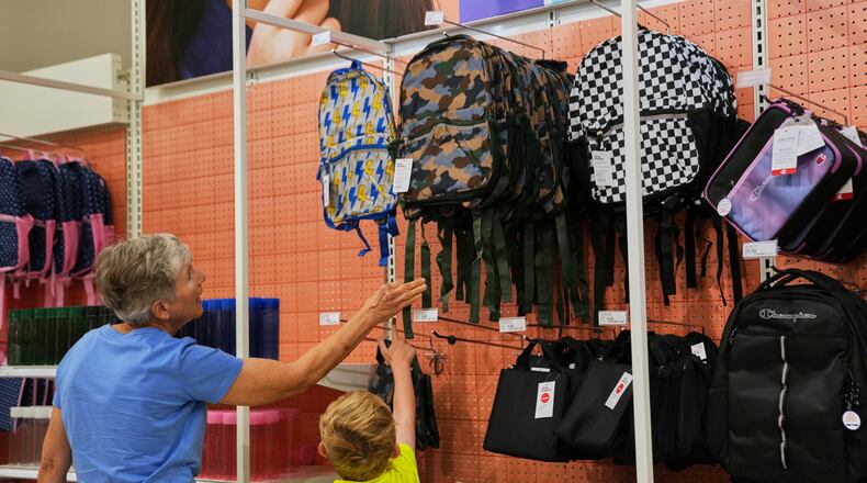 Shoppers choose a backpack at a Target store, Thursday, Aug. 13, 2026, in Woodbury, Minn. (AP Photo/Ellen Schmidt)