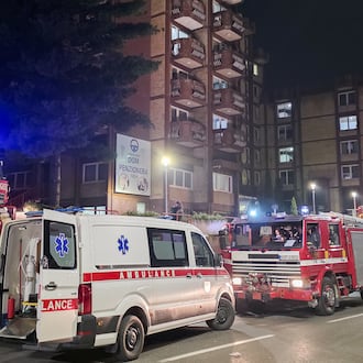 A rescue cars are parked in front of a nursing home after a fire in Tuzla, Bosnia, Tuesday, Nov. 4, 2025. (AP Photo)