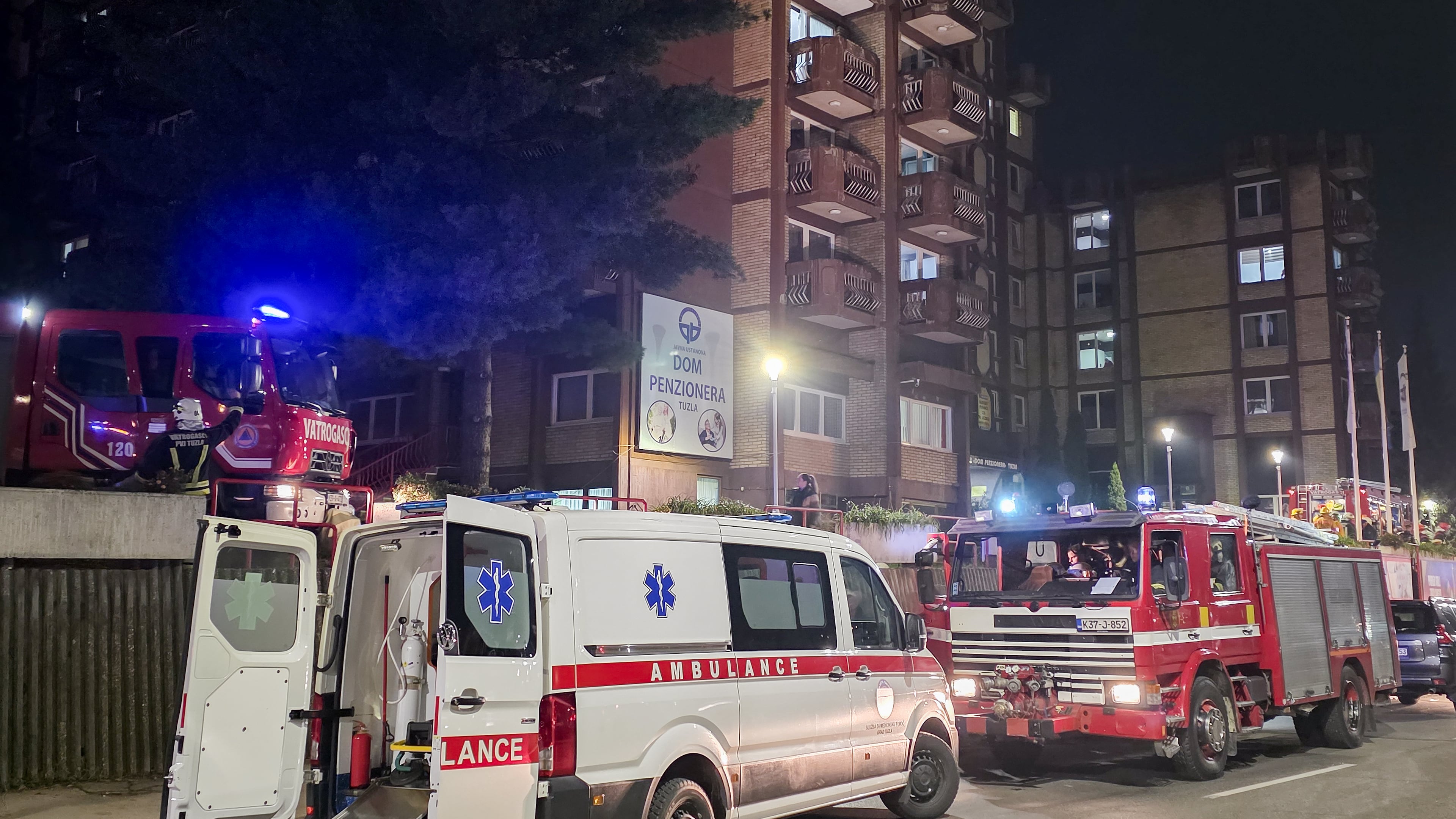 A rescue cars are parked in front of a nursing home after a fire in Tuzla, Bosnia, Tuesday, Nov. 4, 2025. (AP Photo)