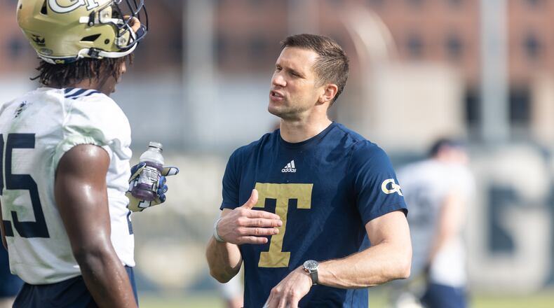 Defensive coordinator Andrew Thacker talks with Charlie Thomas (25) during the first day of spring practice for Georgia Tech football at Alexander Rose Bowl Field in Atlanta, GA., on Thursday, February 24, 2022. (Photo Jenn Finch)