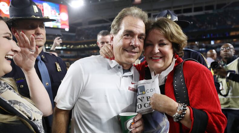 Head coach Nick Saban of the Alabama Crimson Tide celebrates with his wife after the win over the Oklahoma Sooners.