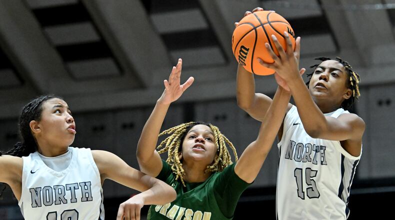 North Paulding's Ava Andrews (15) grabs a rebound over Grayson's Erin Rodgers (23) during the first half of GHSA Basketball Class 7A Girl’s State Championship game at the Macon Centreplex, Saturday, Mar. 9, 2024, in Macon. (Hyosub Shin / Hyosub.Shin@ajc.com)