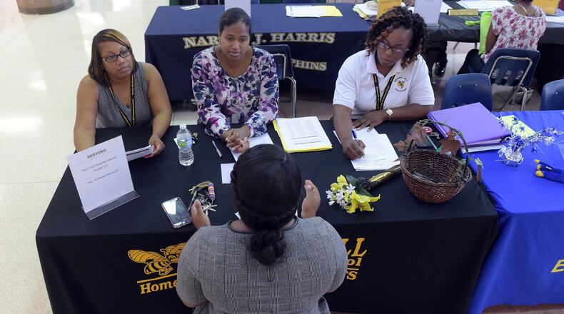 A prospective teacher is interviewed by school representatives during a July job fair in DeKalb County. KENT D. JOHNSON / AJC