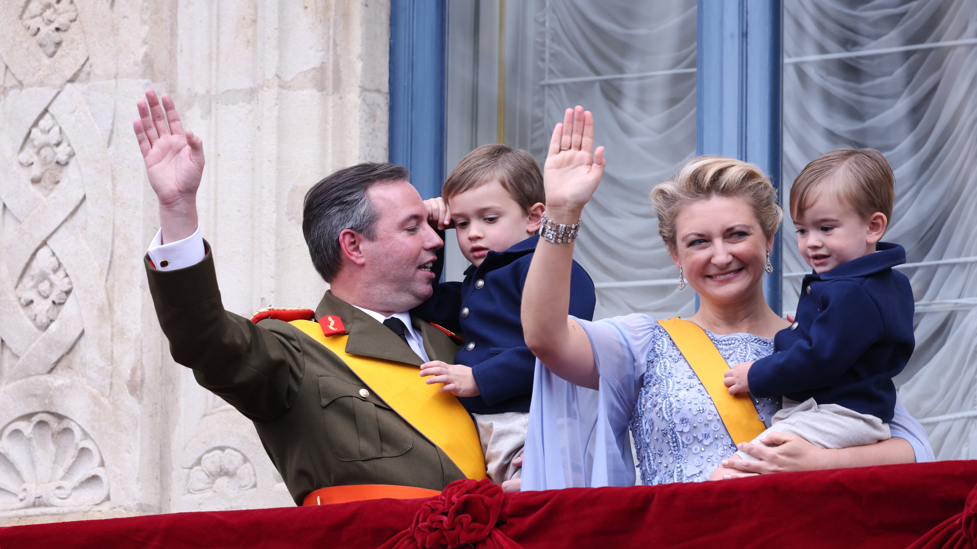 Luxembourg's Grand Duke Guillaume and Luxembourg's Grand Duchess Stephanie hold their children Prince Charles and Prince Francois as they wave from the balcony of the Grand Ducal Palace in Luxembourg, Friday, Oct. 3, 2025. (AP Photo/Omar Havana)