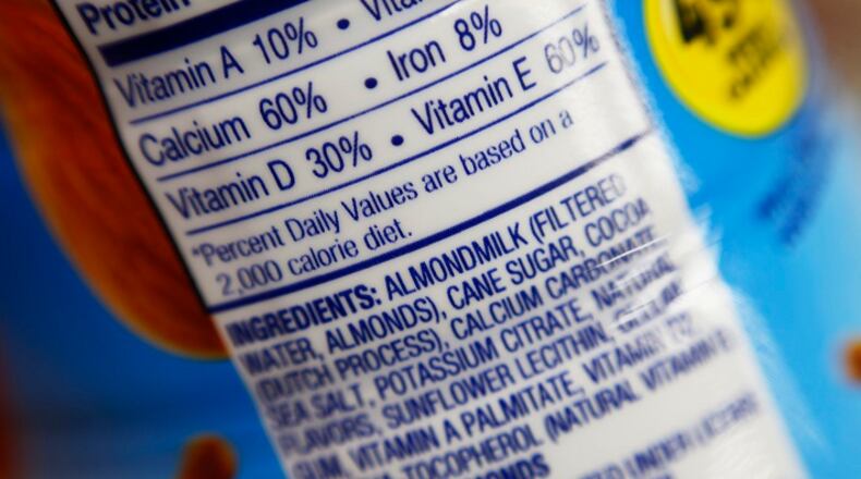 This Thursday, Feb. 16, 2017, photo shows the ingredients label for almond milk at a grocery store in New York. Dairy producers are calling for a crackdown on the almond, soy and rice "milks" they say are masquerading as the real thing and cloud the meaning of milk for shoppers. A group that advocates for plant-based products has countered by asking the Food and Drug Administration to say foods can use terms such as "milk" and "sausage," so long as they're modified to make clear what's in them. (AP Photo/Patrick Sison)