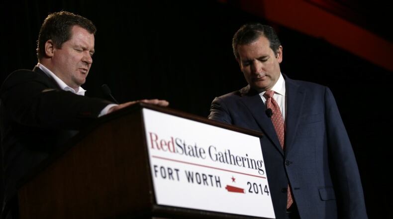 Erick Erickson, left, and Ted Cruz pray at the 2014 RedState gathering. AP photo