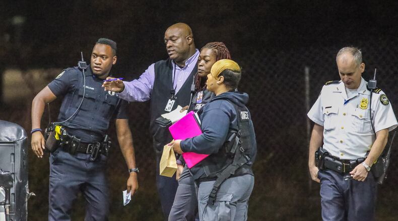 Atlanta police investigate a shooting that injured a man in the stomach Tuesday outside a Chevron on Donald Lee Hollowell Parkway. JOHN SPINK / JSPINK@AJC.COM