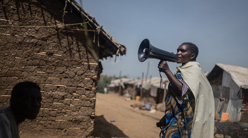 Machozi Naumi, 45, raises awareness of Ebola in the camp on the property of the city's ISP (Institut Supérieur Pédagogique), where internally displaced people reside in Bunia, Congo, Tuesday, May 26, 2026. (AP Photo/Moses Sawasawa)