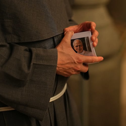 Christian Catholic priest Father Andrew holds photographs of Pope Leo XIV following a mass at St. Anthony of Padua Catholic church, in Istanbul, Turkey, Tuesday, Nov. 18, 2025, ahead of the visit of Pope Leo XIV to Turkey. (AP Photo/Francisco Seco)