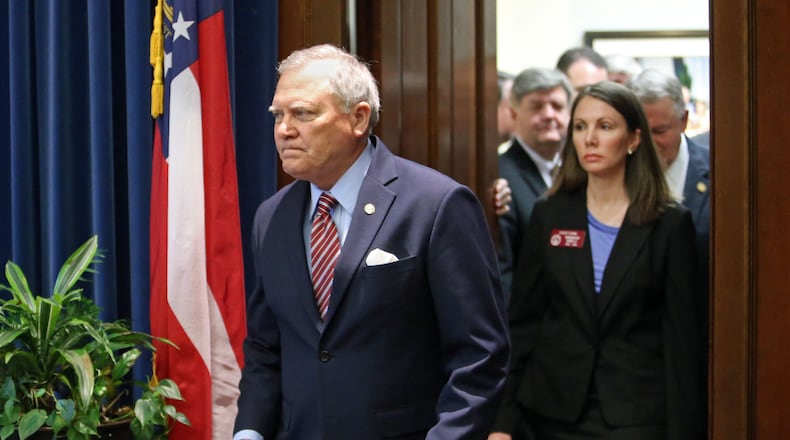 Gov. Nathan Deal walks in with Rep. Stacey Evans, D-Smyrna. JASON GETZ / JGETZ@AJC.COM