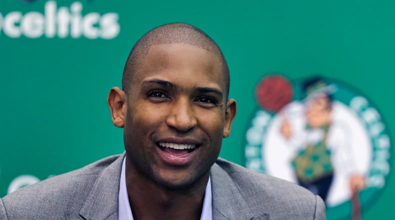 Boston Celtics forward Al Horford smiles during a media availability at the team's practice facility, Friday, July 8, 2016, in Waltham, Mass. Horford agreed to a four-year, $113 million deal with the Celtics as an unrestricted free agent, ending nearly ten years with the Atlanta Hawks. (AP Photo/Charles Krupa)