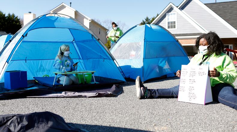 Alice listens to her leader Tracey Clark teach in Smyrna, Georgia, on Saturday, Dec. 5, 2020. Tracey Clark has been leading an experiential learning activity in her neighborhood cul-de-sac where students learn together while social distanced in tents.(Rebecca Wright for The Atlanta Journal-Constitution)