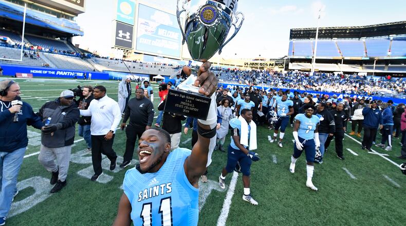 Cedar Grove's Isaiah Ratcliff celebrates with the trophy.