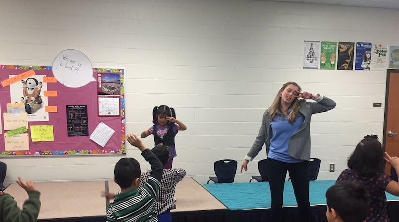 Graves Elementary School teacher Sarah Jones leads a kindergarten class in a dance exercise before acting out “The Tortoise and The Hare.” “When we move our body, we do good things for our brain,” she told the students. ERIC STIRGUS / ESTIRGUS@AJC.COM