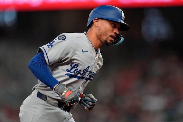 Los Angeles Dodgers' Mookie Betts (50) celebrates his solo homer against the Atlanta Braves in the sixth inning of a baseball game, Friday, May 2, 2025, in Atlanta. (AP Photo/Mike Stewart)