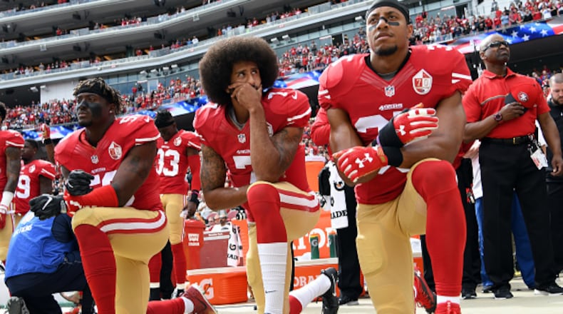 SANTA CLARA, CA - OCTOBER 02: (L-R) Eli Harold #58, Colin Kaepernick #7 and Eric Reid #35 of the San Francisco 49ers kneel on the sideline during the anthem prior to the game against the Dallas Cowboys at Levi's Stadium on October 2, 2016 in Santa Clara, California. (Photo by Thearon W. Henderson/Getty Images)