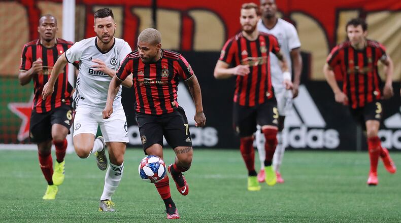 Atlanta United striker Josef Martinez breaks away from Philadelphia Union defender Haris Medunjanin to drive down the pitch Sunday, March 17, 2019, in Atlanta.