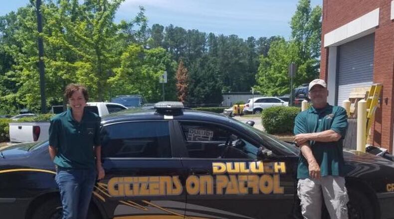 Two of Duluth’s first ‘Citizens on Patrol’ graduates stand with their specially marked car which will be used for patrol throughout the city. Courtesy Duluth Police Department