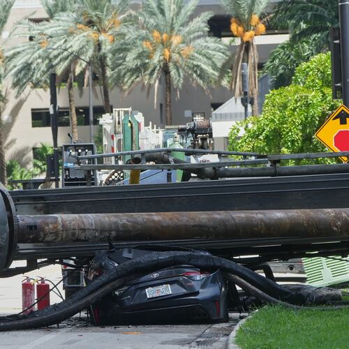 A large construction crane collapsed and crushed a car on Monday, Sept. 14, 2026, in Miami. (AP Photo/Marta Lavandier)