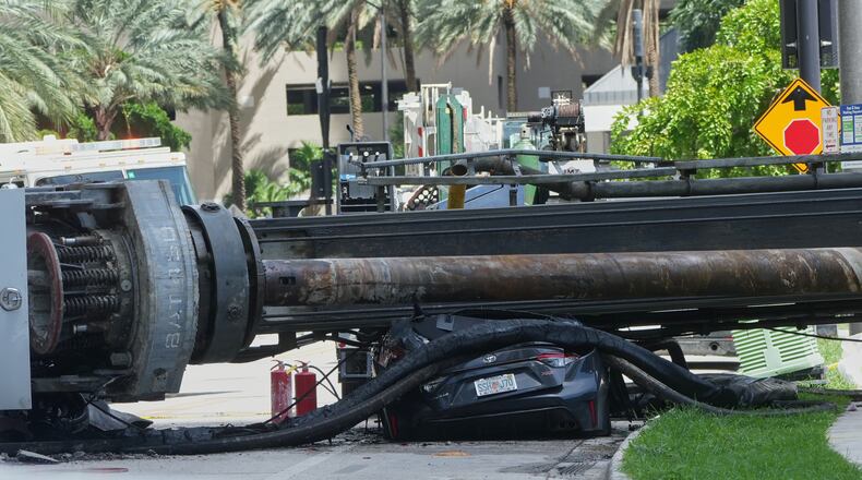 A large construction crane collapsed and crushed a car on Monday, Sept. 14, 2026, in Miami. (AP Photo/Marta Lavandier)