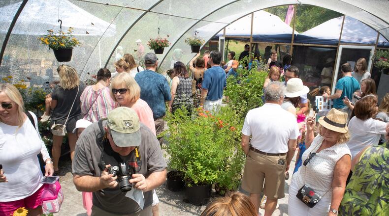 Fairgoers fill the Butterfly Encounter taking photographs and looking at Butterflies during the 20th Annual Flying Colors Butterfly Festival at the Chattahoochee Nature Center in Roswell June 2, 2019. STEVE SCHAEFER / SPECIAL TO THE AJC