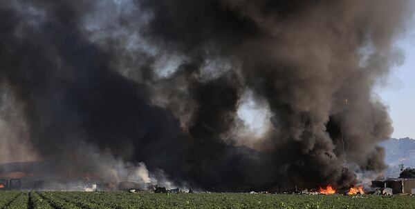 Smoke and flames rise during a fireworks warehouse explosion near Esparto, Calif., Tuesday, July 1, 2025. (Kent Porter/The Press Democrat via AP)