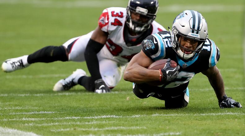 CHARLOTTE, NORTH CAROLINA - DECEMBER 23: Brian Poole #34 of the Atlanta Falcons tries to stop D.J. Moore #12 of the Carolina Panthers during their game at Bank of America Stadium on December 23, 2018 in Charlotte, North Carolina. (Photo by Streeter Lecka/Getty Images)
