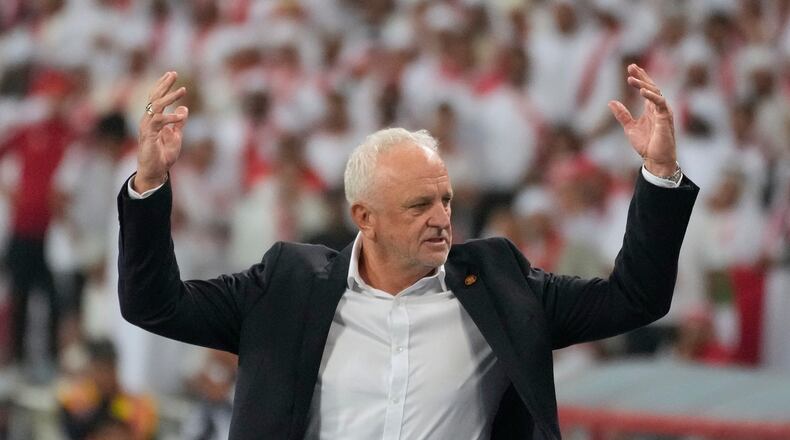 Iraqi's head coach Graham Arnold celebrates his team's win during the 2026 World Cup play off second leg soccer match between UAE and Iraq, in Basra, Iraq, Nov. 18, 2025. (AP Photo/Hadi Mizban)