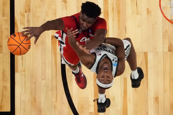 Mississippi forward Malik Dia (0) blocks the shot on Michigan State guard Tre Holloman (5) during the first half in the Sweet 16 of the NCAA college basketball tournament, Friday, March 28, 2025, in Atlanta. (AP Photo/George Walker IV)