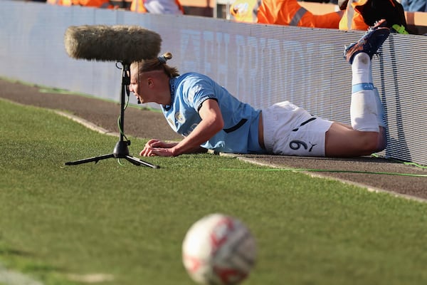 Manchester City's Erling Haaland reacts after sustaining an injury during the English FA Cup quarterfinal soccer match between Bournemouth and Manchester City at the Vitality stadium in Bournemouth, England, Sunday, March 30, 2025. (AP Photo/Ian Walton)