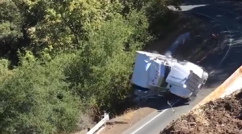 A semi trying to navigate a steep curve fell off an embankment Thursday in California, officials said.