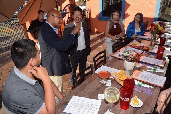 Democrat Shawn Harris speaks with Latino voters in Dalton. Harris’ campaign significantly improved Democratic margins in Whitfield County during the closely watched race. (Courtesy of Andrea Nicole)
