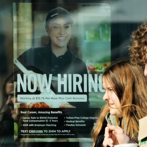 A hiring sign is displayed at a restaurant, in Niles, Ill., Tuesday, April 7, 2026. (AP Photo/Nam Y. Huh)