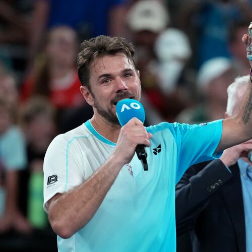 Stan Wawrinka of Switzerland holds up a beer following his third round loss to Taylor Fritz of the U.S. at the Australian Open tennis championship in Melbourne, Australia, Saturday, Jan. 24, 2026. (AP Photo/Asanka Brendon Ratnayake)