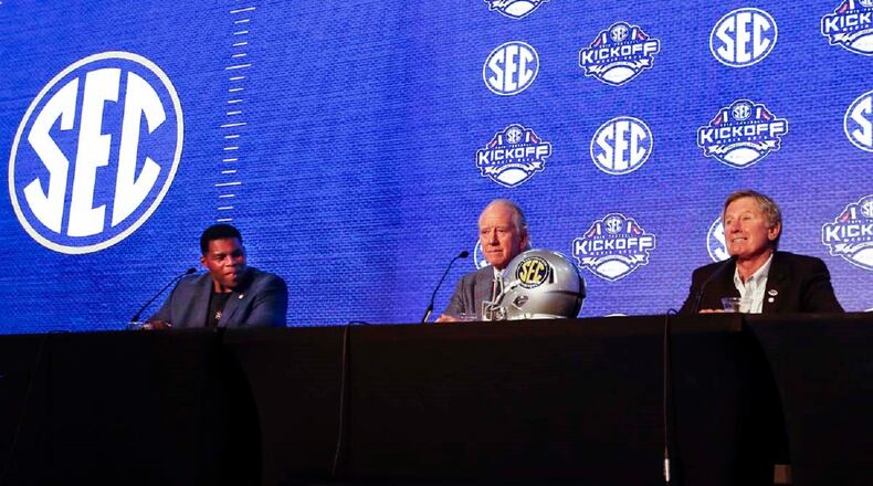 Herschel Walker, left, Archie Manning, center, and Steve Spurrier talk about 150 years of college football during the NCAA college football Southeastern Conference Media Days, Tuesday, July 16, 2019, in Hoover, Ala. (AP Photo/Butch Dill)