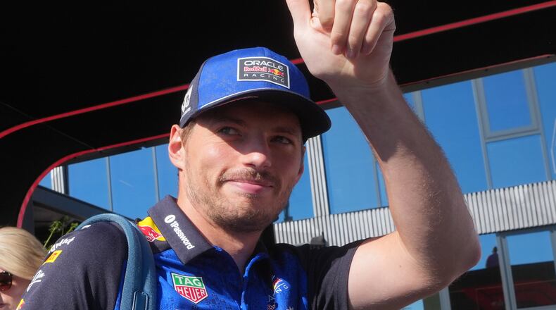 Red Bull driver Max Verstappen of the Netherlands gives a thumbs up to fans as he arrives in the paddock prior to the first free practice ahead of Sunday's Italy Grand Prix, at the Monza racetrack, Italy, Friday, Sept. 4, 2026. (AP Photo/Luca Bruno)