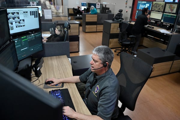 Robert Ebberman, Emergency Communications Officer, answers a 911 emergency call at Cobb County’s 911 call and dispatch center, Tuesday, March 11, 2025, in Marietta. (Hyosub Shin / AJC)