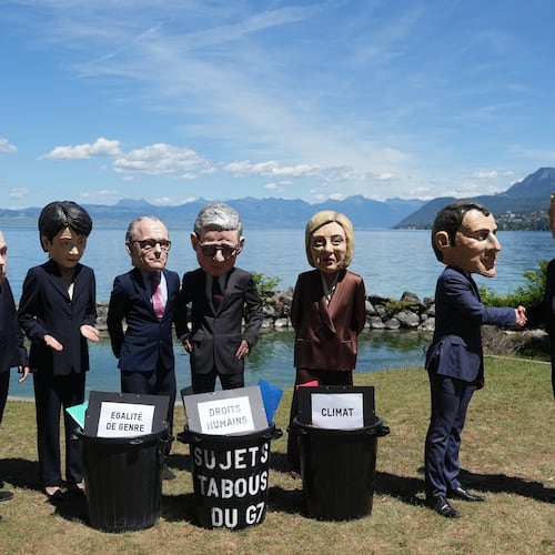Oxfam's satirical 'big heads' of the G7 leaders pose, in Evian-les-Bains, France, Sunday, June 14, 2026, ahead of the G7 summit scheduled to take place in France June 15-17. (AP Photo/Thibault Camus)