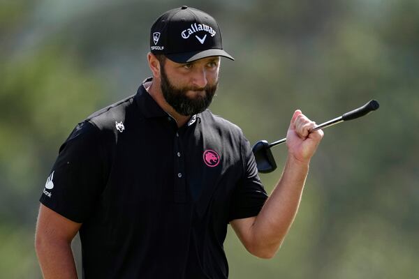 Jon Rahm, of Spain, waves after making a putt on the 18th hole during the second round at the Masters golf tournament, Friday, April 11, 2025, in Augusta, Ga. (AP Photo/George Walker IV)