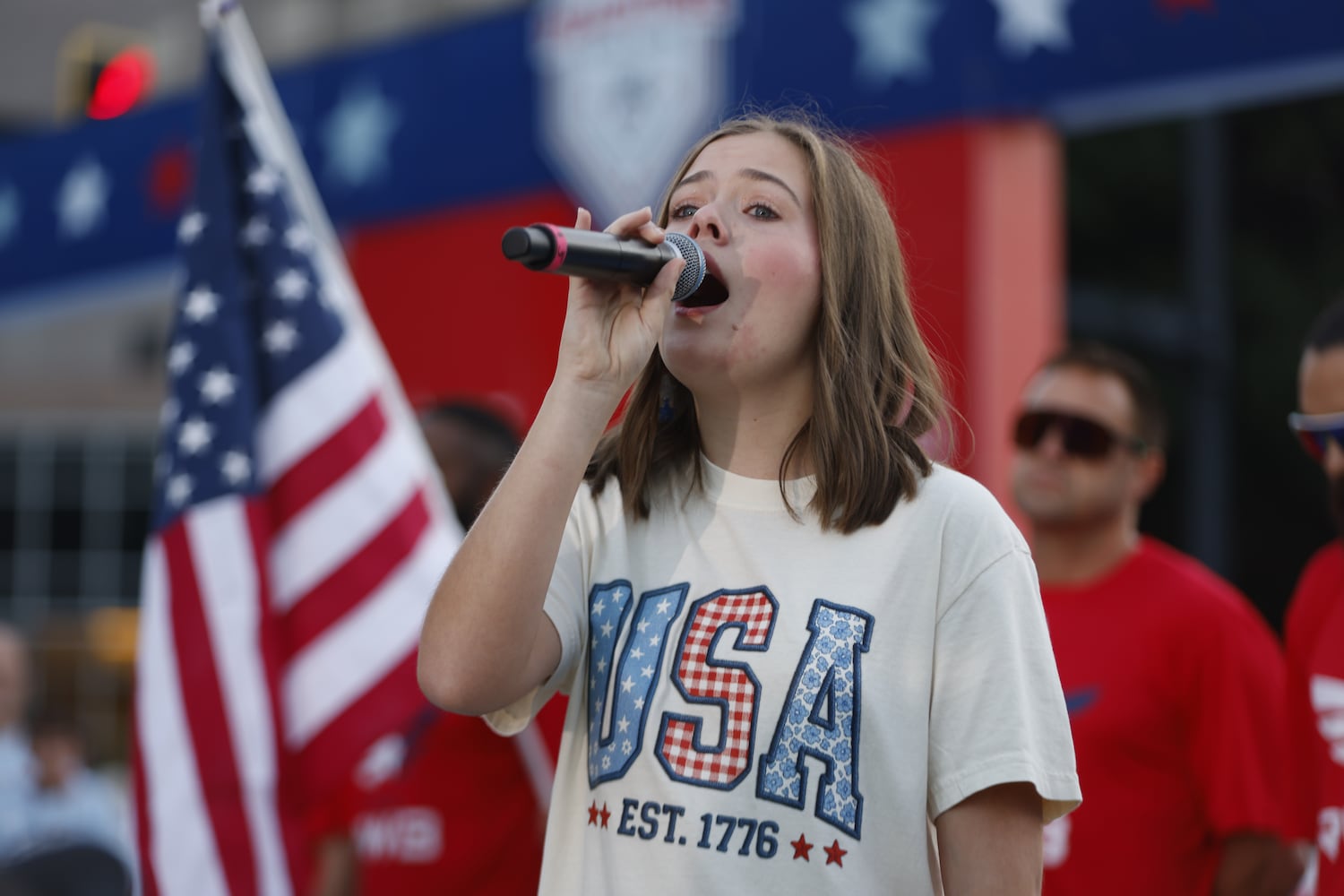 Peachtree Road Race anthem winner Laura Martin sings at the start of the 56th running of the Atlanta Journal-Constitution Peachtree Road Race on Friday, July 4, 2025, in Atlanta. (Arvin Temkar/AJC)