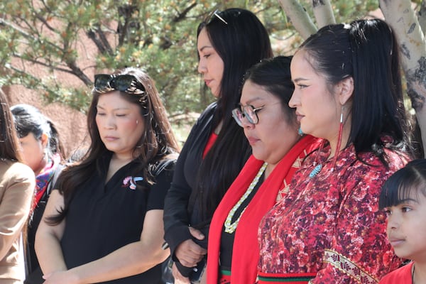 A group of women listen to a prayer before participating in a walk marking Missing and Murdered Indigenous Persons Awareness Day at the Indian Pueblo Cultural Center in Albuquerque, New Mexico, on Monday, May 5, 2025. (AP Photo/Susan Montoya Bryan)