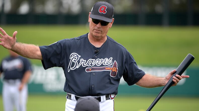Braves manager Brian Snitker talks with infielder Freddie Freeman during the first full-squad spring training workout in Lake Buena Vista, Fla. (AP Photo/Phelan M. Ebenhack, File)